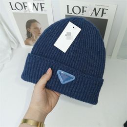 Factory spot e-commerce for knitted hats men's metal brand solid Colour wool hats ladies warm pullover hats wholesale.