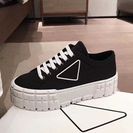 Prad rubber platform inspired by motocross tires defines the unusual design these nylon gabardine sneakers. The triangle decorateFAG