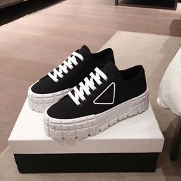 Prad rubber platform inspired by motocross Tyres defines the unusual design these nylon gabardine sneakers. The triangle decorate50 mm