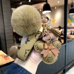 2023 integrity Designer keychain bear head leather fur ball pendant key chain bow car pendant metal fashion personality creative cute
