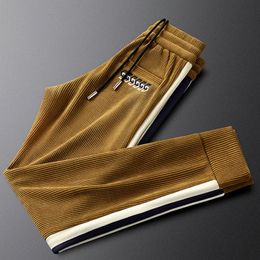 Men's Tracksuits Light luxury side ribbon corduroy pants men's slim warm casual sports striped velvet trousers winter 230818