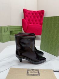 2023 SS latest rain boots. Exclusive open, interlocking double G's take on a new look in this glossy rubber ankle boot4