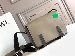 Military messenger bag has a zippered top compartment and an additional front compartment with flap magnetic closure and is crafted in imported calfskin