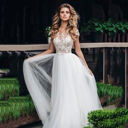 Abiti da sposa Illusion senza maniche per la sposa Classico tulle con bottoni ricoperti di cavità Attraente Sweep Train Applique Sash A-Line