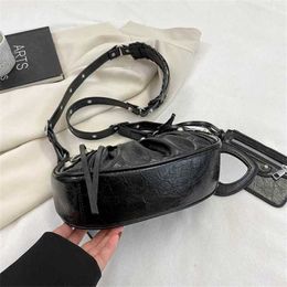 Designer women's handbag 90% off New Locomotive Underarm Wrapped with Rivets Tassels Three in Teeth Wrinkled One Shoulder Crossbody Women's Bag