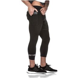 Pants 2021 Hot Sale Muscle Fitness Running Sports Casual Pants QuickDrying TightFitting Fake TwoPiece Stretch NinePoint Pants Men