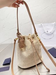 Famous brand designer drawstring womens straw bucket bag triangle logo hollowed out woven straw tote bag fashion summer beach handbag bucket bag