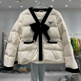 Autumn and winter women's V-neck short light down jacket, chest with bow, foreign style and fashion, women travel short small fragrant wind coat.