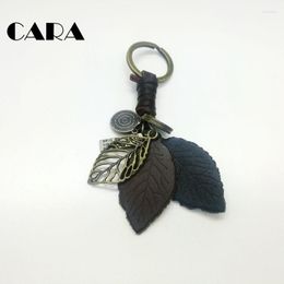 Keychains CARA Arrival Hollow Out Metal Tree Leaf Cow Leather Leaves Bag Hanging Charm Stylish Key Chains Rings Fashion CARA0187