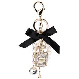 Creative diamond perfume bottle keychains car bag key ring holder pearl bow pendant accessories decoration party gift