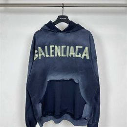 Balencaigaa Paris Autumn and Winter 23 New Yellow Tape Printing Letter Washable Hole Hooded Sweater with Loose Fit for Men and Women Couples
