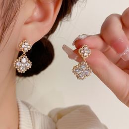 Net red sweet temperament, glory, rice beads four -leaf flower earrings s925 silver needle niche design sense high -level sensor earrings