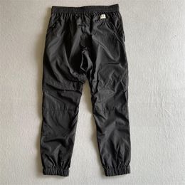 2023 SS Metal nylon men pants one lens logo zipper pocket male pant outdoor tracksuit casual jogging trousers black