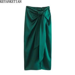 Skirts KEYANKETIAN spring new women's silk satin texture knot decoration high waist long half skirt dark green slit MIDI skirt P230420