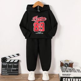 Clothing Sets 4 7 year old boys autumn and winter trend letter number printed black hooded sweater long sleeved pants set 231120