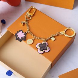 Golden keychain for car key women bag pendant decorative charm girls gift luxury brand design metal letter round buckle