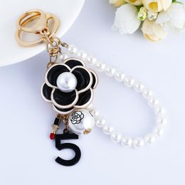 Keychains XDPQQ Korea Creative Tea Tree Flower Pearl Keychain Pendant Metal Couple Fred22