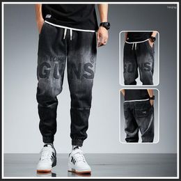 Jeans da uomo Moda 2023 Lettera sfumata stampata Pantaloni cargo da uomo neri da cowboy Hip Hop Pantaloni di lusso Stile coreano Lavoro largo