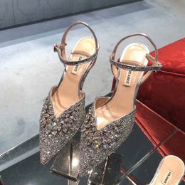 Shimmer like a fairy with these hollowed-out sandals featuring a rhinestone-adorned strap and a pointed, high heel