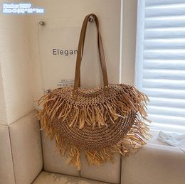 Factory wholesale ladies shoulder bags 2 Colours summer cool hollow woven bag outdoor holiday straw casual beach handbag large tassel fashion backpack