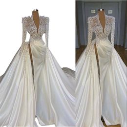 2022 Sexy Luxury Long Sleeves Mermaid Wedding Dresses Deep V Neck Illusion Pearls Crystal High Side Split Arabic Satin Bridal Gown179w