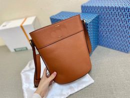 2023 new bucket bag, mobile phone bag, glossy hardware, hollow logo, luxury fashion crossbody bag, versatile bag, brand name bag, wear-resistant and non-fading