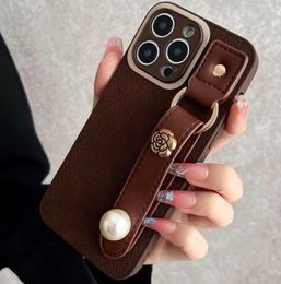 Autumn and Winter New Wrist Strap Phone Case Suitable for 15 promax 14 Women 13 Camellia 12 Full Pack 11
