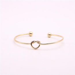 Fashion lovely knotted bangles iron alloy electroplated gold bangle for gift whole339m