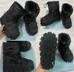 Nylon gabardine ski boots Black Upper with drawstring padded pile lining Enameled metal triangle logo booties rubber sole designer ski boots