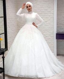 2023 Crystals Beaded Muslim A-Line Wedding Dresses Long Sleeves High Neck Lace Applique Beading Tassel Hijab Bridal Gowns Elegant Luxury Floor Length Dubai Gelinlik