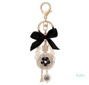 Lovely cute bow pearl flower perfume bottle keychains new fashion ins luxury designer diamond rhinestone bag charm5446618