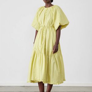 Australian designer dress with round neck, short sleeved lantern sleeves, waistband tied with organic cotton embroidery, yellow vintage dress