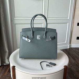 Designväskor lyxiga mode totes silver knapp yttre söm palm mönster väska läder handväska mode kohud handväska mångsidig struktur kvinnors väska ny