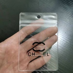 Saco de armazenamento de jóias pvc transparente pendurado buraco saco de identificação manga plástico designer clássico logotipo impressão à prova de poeira saco auto selagem 100 pc/lote atacado