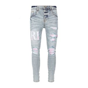 Jeans blu patchwork rosa ricamati con logo rosa vecchio danneggiato lavato 23SS