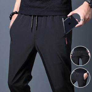 Calças casuais masculinas negócios estiramento fino ajuste cintura elástica jogger coreano clássico azul preto cinza masculino marca calças 240118