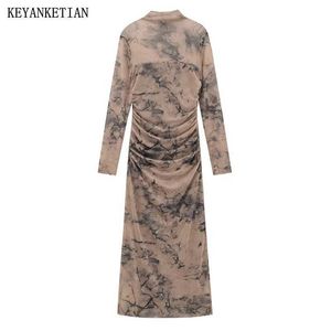 Grundläggande casual klänningar Keyanketian lanserar en kvinnors fjäder veckad dekorativ bläck tryck retro mesh klänning med en vanlig krage sidospelare och snäv fotled lång kjol j24