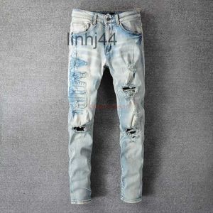 Herren Jeans Designerkleidung Amires Denim Hosen Amies 697 Street Broken Letter Sticker Cloth Used Wash Water Elastic Fit Ins BlueONU1