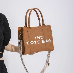 Kvinnors nya Thetotebag Canvas Tote Fashion Wide Shoulder Strap Crossbody Bag 2024 Design Fashion 78% RABATT STORE POCHEOM