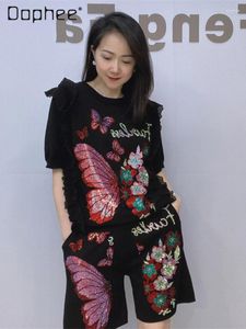 女性用トラックスーツフリル半袖の丸い首のトップとショートパンツ2ピースセット女性服をゆるめる夏の黒蝶のラインストーンセット