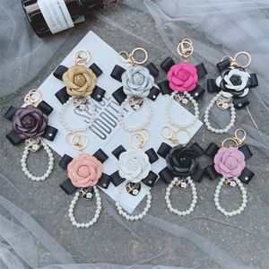 Mode New Bowknot Camellia Keychain Creative Pearl Chain Pu Leather Rose Flower Bag Car Keychain Pendant Accessories216m