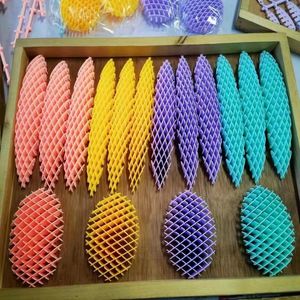 Hot selling 10cm compression elastic net Fidget worm deformation worm poppet release fingertip sensor compression toy keychain