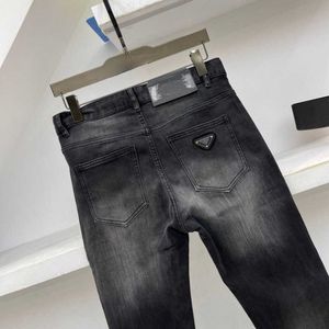 Designer mens jeans elasticitet jean lyx 5a jeans mode triangel denim byxor mens kvinnor smala stretch jeans affärer små fötter slacks 15852 märke denim byxa