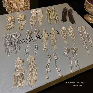 2024 Designer 925 Silver Needle Exquisite Full Diamond Long Tassel örhängen Kvinnlig ins snygg ljus lyxigt litet populärt nätverk Röd Samma båge örhängen fabrik