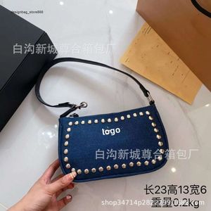 Designer's New Wholesale Price Fashion Bag the Same Style of Has High-end and Minimalist Feel with Simple Rivet Grip. It Is Made Fragrant Cloth Denim Fabric Underarm