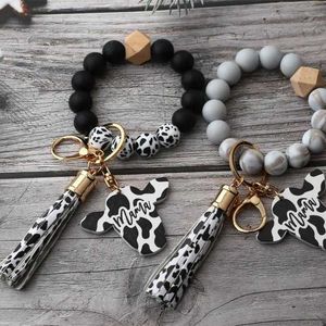 Designer Keychains Lanyards 2024 Fashion Silicone Cursive Cow Bead Bracelet Wood Disk Bracelet Cow Tassel Ox Head Wrist Key Ring Charm Pendant Accessory FY3450 tt03