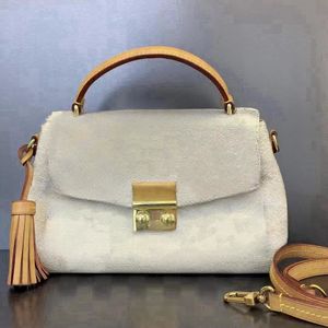 Designer white checkered handbag with tassels, stylish luxury bags