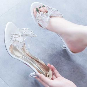 Klänningskor Nya koreanska stilar tofflor Sweet Butterfly-Knot Sandaler Transparent Crystal Thin High Heels Wedding Temperament Women H24032501