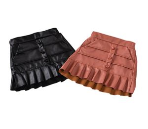 Flickor korta läder kjolar barn elastiska ruffle kjol småbarn baby knapp pocket miniskirt barn fasta kläder veterbörd bebe ropa b2607815