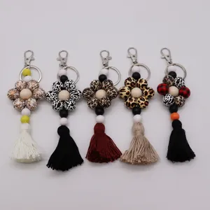 Commercio all'ingrosso di nuovi pendenti con perline, borse, pendenti, accessori da donna, portachiavi creativi con nappe con perline in legno con stampa leopardata